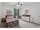 Bright bedroom featuring a ceiling fan, light gray walls, and a charming window with blue curtains at 1280 Gin House Ln, Lawrenceville, GA 30045