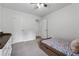 Cozy bedroom showing a twin bed, gray carpet and white walls at 1280 Gin House Ln, Lawrenceville, GA 30045