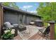 Comfortable deck with outdoor seating, grill, and charming patio furniture and string lights at 1280 Gin House Ln, Lawrenceville, GA 30045