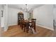 Dining room featuring hardwood floors, modern chandelier, and decorative wainscotting at 1280 Gin House Ln, Lawrenceville, GA 30045