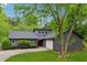 Charming home featuring a gray exterior, manicured landscaping, and a welcoming red front door at 1280 Gin House Ln, Lawrenceville, GA 30045