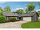 Well-maintained exterior of a gray home with a two-car garage and a neatly paved driveway at 1280 Gin House Ln, Lawrenceville, GA 30045