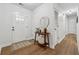 Bright foyer showcasing hardwood floors, a white front door, and decorative accents on a console table at 1280 Gin House Ln, Lawrenceville, GA 30045