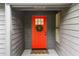 Inviting front entrance featuring a vibrant red door, wreath, and a 'Home Sweet Home' doormat at 1280 Gin House Ln, Lawrenceville, GA 30045