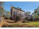 Side yard view of home with backyard lawn at 1627 Isham Dr, Lawrenceville, GA 30046