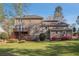 Expansive backyard with lush greenery, flowering bushes, and a spacious deck, ideal for outdoor gatherings at 1627 Isham Dr, Lawrenceville, GA 30046