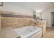 Spacious bathroom with a large tub and tiled surround, offering a relaxing retreat within the home at 1627 Isham Dr, Lawrenceville, GA 30046