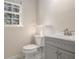 Bathroom featuring gray vanity and a standard toilet at 1627 Isham Dr, Lawrenceville, GA 30046