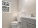 Powder room with gray vanity, silver faucet, and granite counters at 1627 Isham Dr, Lawrenceville, GA 30046