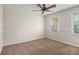 Bright bedroom features carpeted floor, ceiling fan, and two windows at 1627 Isham Dr, Lawrenceville, GA 30046