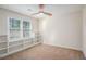 Bedroom with built-in shelving and a ceiling fan, providing storage and comfort at 1627 Isham Dr, Lawrenceville, GA 30046