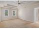 Spacious bedroom with trey ceiling, a ceiling fan, and natural light from two large windows at 1627 Isham Dr, Lawrenceville, GA 30046