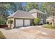 Exterior view of a two-story home, with a large driveway and well manicured shrubbery at 1627 Isham Dr, Lawrenceville, GA 30046