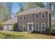 Charming home with a two-car garage, well-manicured lawn, and mature trees offering great curb appeal at 1627 Isham Dr, Lawrenceville, GA 30046