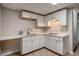 Basement kitchenette with white cabinets, countertops, sink, and two-burner cooktop at 1627 Isham Dr, Lawrenceville, GA 30046