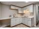 Basement kitchen with white cabinets, white countertops and stainless steel sink at 1627 Isham Dr, Lawrenceville, GA 30046