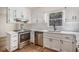 Bright kitchen featuring stainless appliances, white cabinets, and modern finishes at 1627 Isham Dr, Lawrenceville, GA 30046
