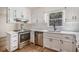 Modern kitchen featuring stainless steel appliances, white cabinetry, and subway tile backsplash at 1627 Isham Dr, Lawrenceville, GA 30046