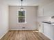 Bright breakfast nook features updated flooring and cabinet space and a view to the outdoors at 1627 Isham Dr, Lawrenceville, GA 30046