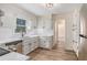 Bright kitchen with updated appliances, white cabinets, and modern countertops and finishes at 1627 Isham Dr, Lawrenceville, GA 30046