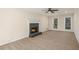 Spacious living room with a fireplace, neutral carpet, and large windows at 1627 Isham Dr, Lawrenceville, GA 30046