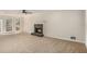 Spacious living room featuring a cozy fireplace, ceiling fan, and natural light at 1627 Isham Dr, Lawrenceville, GA 30046