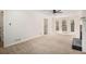 Inviting living room with a fireplace, light-colored carpet, and multiple entryways at 1627 Isham Dr, Lawrenceville, GA 30046