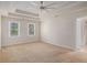 Spacious main bedroom featuring a trey ceiling, ceiling fan, and carpet at 1627 Isham Dr, Lawrenceville, GA 30046