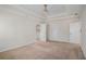 Spacious main bedroom with tray ceiling, fan, carpet, and multiple closets at 1627 Isham Dr, Lawrenceville, GA 30046