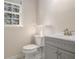Stylish powder room features a gray vanity, brushed nickel fixtures, and tiled floors at 1627 Isham Dr, Lawrenceville, GA 30046
