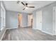 This spacious bedroom has gray walls, light-colored laminate floors, and a modern ceiling fan with light at 3918 S Creek Ct, Stone Mountain, GA 30083