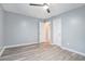 Comfortable bedroom featuring neutral paint, wood-look floors, and two closets for storage at 3918 S Creek Ct, Stone Mountain, GA 30083