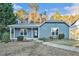 Charming single-story home with blue siding, a covered front porch, and a landscaped front yard at 3918 S Creek Ct, Stone Mountain, GA 30083