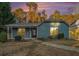Charming single-story home with blue siding, a covered front porch, and a landscaped front yard at 3918 S Creek Ct, Stone Mountain, GA 30083