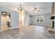 Bright living room showcasing gray walls, wood-look floors, a stone fireplace, and access to the kitchen at 3918 S Creek Ct, Stone Mountain, GA 30083