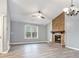Spacious living room with a vaulted ceiling, stone fireplace, and large window offering natural light at 3918 S Creek Ct, Stone Mountain, GA 30083