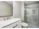 Bathroom with white vanity and glass shower enclosure with gray tiling at 65 Sage St, Temple, GA 30179