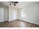 Bedroom with ceiling fan, closet, and window with natural light and wood-look flooring at 65 Sage St, Temple, GA 30179
