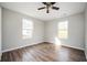 Bright bedroom featuring wood-look floors, a ceiling fan, and two windows at 65 Sage St, Temple, GA 30179