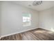 Simple bedroom with ceiling fan, closet, and window with natural light and wood-look flooring at 65 Sage St, Temple, GA 30179