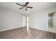 Spacious bedroom with ceiling fan, wood-look flooring, and a bathroom with glass shower at 65 Sage St, Temple, GA 30179