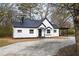 Charming renovated home featuring white siding, black roof, and inviting front entrance at 65 Sage St, Temple, GA 30179