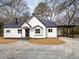 Charming renovated home featuring white siding, black roof, and inviting front entrance at 65 Sage St, Temple, GA 30179