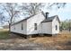 Exterior view of the white house shows the back and side at 65 Sage St, Temple, GA 30179