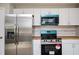 Stainless steel fridge and modern stove with wooden countertops and white cabinetry at 65 Sage St, Temple, GA 30179