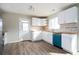 Bright kitchen with white cabinets, stainless appliances, wood counters, and modern backsplash at 65 Sage St, Temple, GA 30179