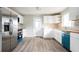 Modern kitchen with white cabinets, stainless steel appliances, and durable countertop at 65 Sage St, Temple, GA 30179