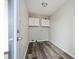 The laundry room features wood-look floors, white cabinets and hookups at 65 Sage St, Temple, GA 30179