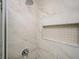 Close up of the modern glass shower with shower niche and neutral-colored tiling at 65 Sage St, Temple, GA 30179