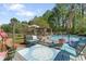 Beautiful backyard with lush green trees features pool, gazebo and lounge seating, perfect for relaxing outdoors at 2062 Cezar Nw Dr, Kennesaw, GA 30152